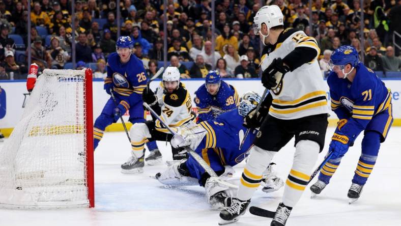 Mar 19, 2023; Buffalo, New York, USA;  Boston Bruins left wing Jake DeBrusk (74) scores a goal on Buffalo Sabres goaltender Ukko-Pekka Luukkonen (1) during the first period at KeyBank Center. Mandatory Credit: Timothy T. Ludwig-USA TODAY Sports