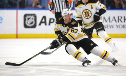 Mar 19, 2023; Buffalo, New York, USA;  Boston Bruins left wing Brad Marchand (63) looks for the puck during the first period against the Buffalo Sabres at KeyBank Center. Mandatory Credit: Timothy T. Ludwig-USA TODAY Sports