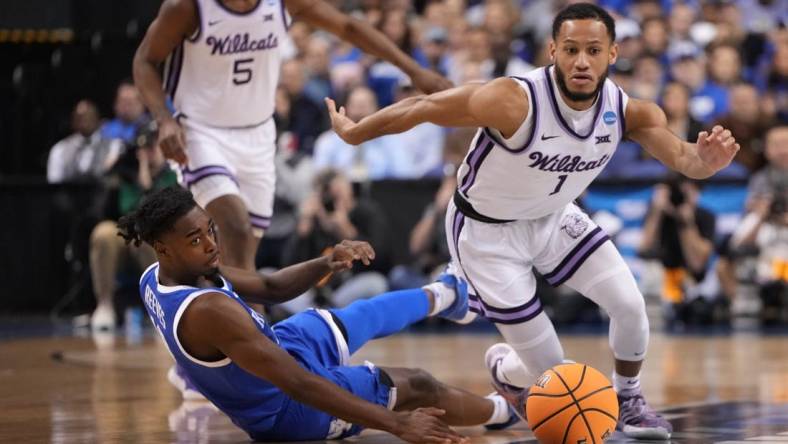 Mar 19, 2023; Greensboro, NC, USA;  Kansas State Wildcats guard Markquis Nowell (1) and Kentucky Wildcats guard Antonio Reeves (12) both go for a loose ball during the first half in the second round of the 2023 NCAA men   s basketball tournament at Greensboro Coliseum. Mandatory Credit: Bob Donnan-USA TODAY Sports