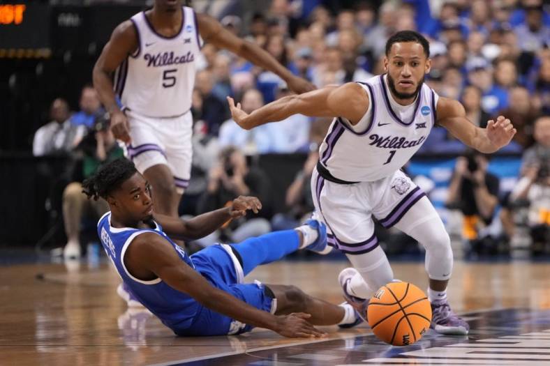 Mar 19, 2023; Greensboro, NC, USA;  Kansas State Wildcats guard Markquis Nowell (1) and Kentucky Wildcats guard Antonio Reeves (12) both go for a loose ball during the first half in the second round of the 2023 NCAA men   s basketball tournament at Greensboro Coliseum. Mandatory Credit: Bob Donnan-USA TODAY Sports