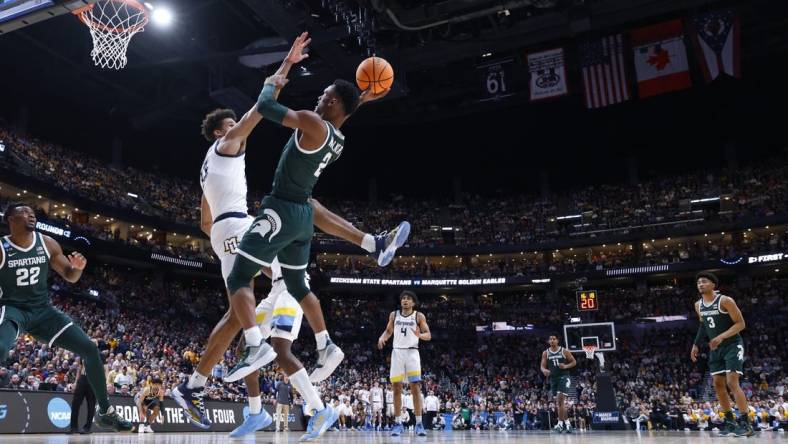 Mar 19, 2023; Columbus, OH, USA; Michigan State Spartans guard Tyson Walker (2) shoots the ball over Marquette Golden Eagles forward Oso Ighodaro (13) in the second half at Nationwide Arena. Mandatory Credit: Rick Osentoski-USA TODAY Sports