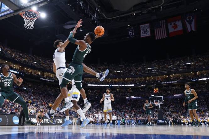 Mar 19, 2023; Columbus, OH, USA; Michigan State Spartans guard Tyson Walker (2) shoots the ball over Marquette Golden Eagles forward Oso Ighodaro (13) in the second half at Nationwide Arena. Mandatory Credit: Rick Osentoski-USA TODAY Sports