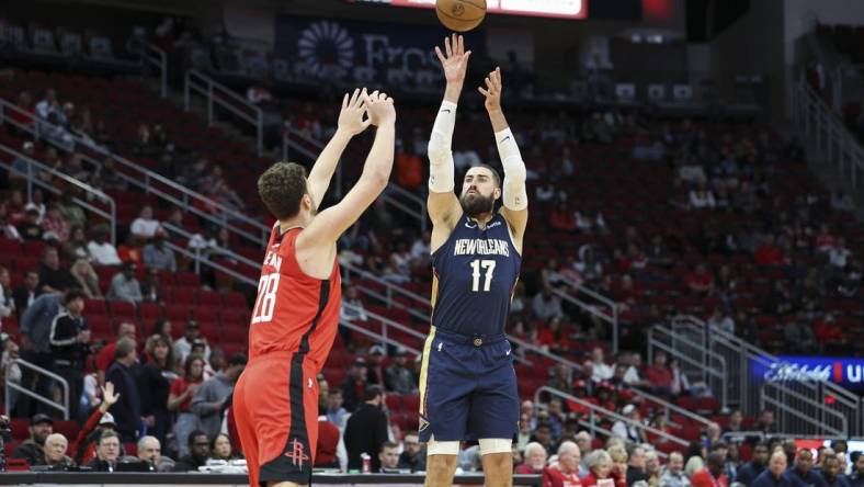 Mar 19, 2023; Houston, Texas, USA; New Orleans Pelicans center Jonas Valanciunas (17) shoots the ball over Houston Rockets center Alperen Sengun (28) during the first quarter at Toyota Center. Mandatory Credit: Troy Taormina-USA TODAY Sports