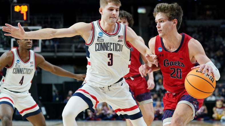 Mar 19, 2023; Albany, NY, USA; St. Mary s Gaels guard Aidan Mahaney (20) dribbles the ball against UConn Huskies guard Joey Calcaterra (3) during the first half at MVP Arena. Mandatory Credit: David Butler II-USA TODAY Sports