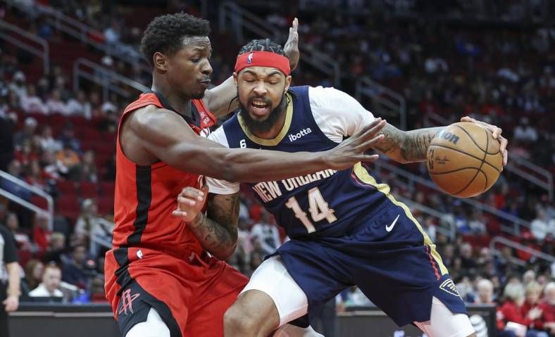 Mar 19, 2023; Houston, Texas, USA; New Orleans Pelicans forward Brandon Ingram (14) controls the ball as Houston Rockets forward Jae'Sean Tate (8) defends during the second quarter at Toyota Center. Mandatory Credit: Troy Taormina-USA TODAY Sports