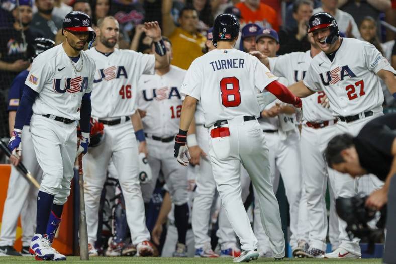 Mar 19, 2023; Miami, Florida, USA; USA shortstop Trea Turner (8) celebrates with teammates after hitting a home run during the second inning against Cuba at LoanDepot Park. Mandatory Credit: Sam Navarro-USA TODAY Sports