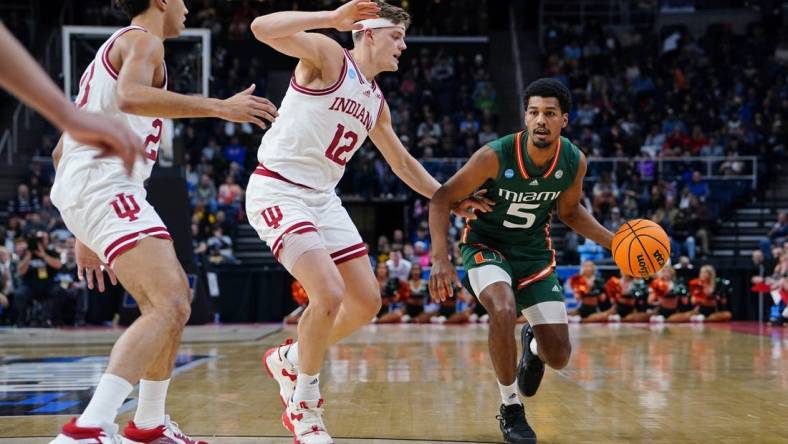 Mar 19, 2023; Albany, NY, USA; Miami (Fl) Hurricanes guard Harlond Beverly (5) drives to the basket against Indiana Hoosiers forward Miller Kopp (12) during the first half at MVP Arena. Mandatory Credit: Gregory Fisher-USA TODAY Sports