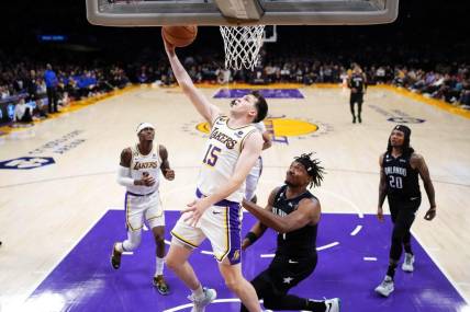 Mar 19, 2023; Los Angeles, California, USA; Los Angeles Lakers guard Austin Reaves (15) shoots against the Orlando Magic in the first half at Crypto.com Arena. Mandatory Credit: Kirby Lee-USA TODAY Sports