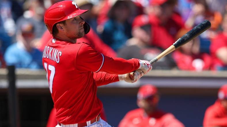 Mar 20, 2023; Clearwater, Florida, USA;  Philadelphia Phillies first baseman Rhys Hoskins (17) hits a two-run home run against the Baltimore Orioles in the second inning during spring training at BayCare Ballpark. Mandatory Credit: Nathan Ray Seebeck-USA TODAY Sports