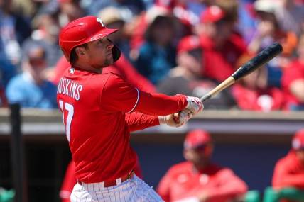 Mar 20, 2023; Clearwater, Florida, USA;  Philadelphia Phillies first baseman Rhys Hoskins (17) hits a two-run home run against the Baltimore Orioles in the second inning during spring training at BayCare Ballpark. Mandatory Credit: Nathan Ray Seebeck-USA TODAY Sports