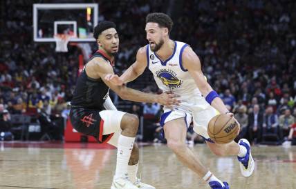 Mar 20, 2023; Houston, Texas, USA; Golden State Warriors guard Klay Thompson (11) drives with the ball as Houston Rockets forward KJ Martin (6) defends during the second quarter at Toyota Center. Mandatory Credit: Troy Taormina-USA TODAY Sports