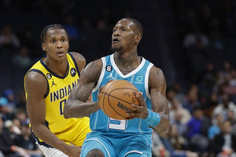 Mar 20, 2023; Charlotte, North Carolina, USA; Charlotte Hornets guard Terry Rozier (3) looks to shoot ahead of Indiana Pacers guard Bennedict Mathurin (00) during the second half at Spectrum Center. The Charlotte Hornets won 115-109. Mandatory Credit: Nell Redmond-USA TODAY Sports