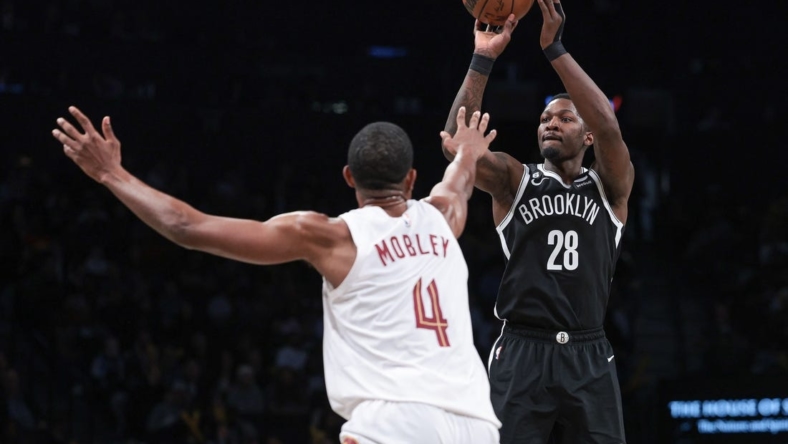 Mar 21, 2023; Brooklyn, New York, USA; Brooklyn Nets forward Dorian Finney-Smith (28) shoots the ball against Cleveland Cavaliers forward Evan Mobley (4) during the second half at Barclays Center. Mandatory Credit: Vincent Carchietta-USA TODAY Sports