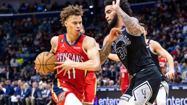 Mar 21, 2023; New Orleans, Louisiana, USA; New Orleans Pelicans guard Dyson Daniels (11) dribbles against San Antonio Spurs forward Julian Champagnie (30)  during the second half at Smoothie King Center. Mandatory Credit: Stephen Lew-USA TODAY Sports