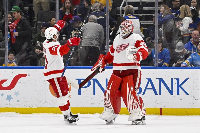 Mar 21, 2023; St. Louis, Missouri, USA;  Detroit Red Wings goaltender Magnus Hellberg (45) and center Dylan Larkin (71) celebrate after the Red Wings defeated the St. Louis Blues in shootouts at Enterprise Center. Mandatory Credit: Jeff Curry-USA TODAY Sports