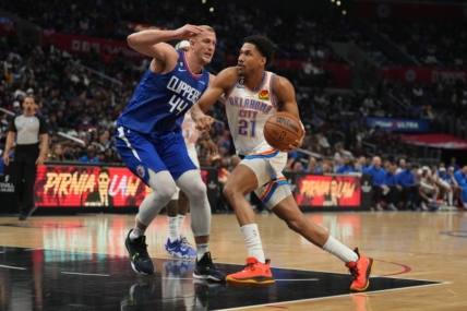 Mar 21, 2023; Los Angeles, California, USA; Oklahoma City Thunder guard Aaron Wiggins (21) dribbles the ball against LA Clippers center Mason Plumlee (44) in the second half at Crypto.com Arena. Mandatory Credit: Kirby Lee-USA TODAY Sports
