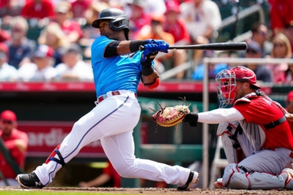 Mar 22, 2023; Jupiter, Florida, USA; Miami Marlins second baseman Jean Segura (9) hits a single against the St. Louis Cardinals during the fourth inning at Roger Dean Stadium. Mandatory Credit: Rich Storry-USA TODAY Sports