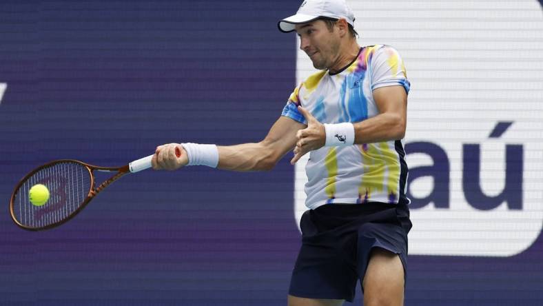 Mar 22, 2023; Miami, Florida, US; Dusan Lajovic (SRB) hits a forehand against Andy Murray (GBR) (not pictured) on day three of the Miami Open at Hard Rock Stadium. Mandatory Credit: Geoff Burke-USA TODAY Sports