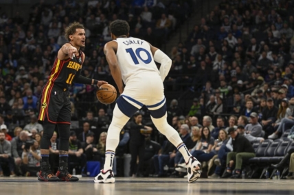 Mar 22, 2023; Minneapolis, Minnesota, USA;  Atlanta Hawks guard Trae Young (11) calls a play as Minnesota Timberwolves guard Mike Conley (10) defends in the second quarter at Target Center. Mandatory Credit: Nick Wosika-USA TODAY Sports