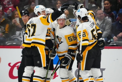 Mar 22, 2023; Denver, Colorado, USA; Pittsburgh Penguins left wing Jake Guentzel (59) celebrates his goal with right wing Rickard Rakell (67) and defenseman Kris Letang (58) and center Sidney Crosby (87) in the second period against the Colorado Avalanche at Ball Arena. Mandatory Credit: Ron Chenoy-USA TODAY Sports