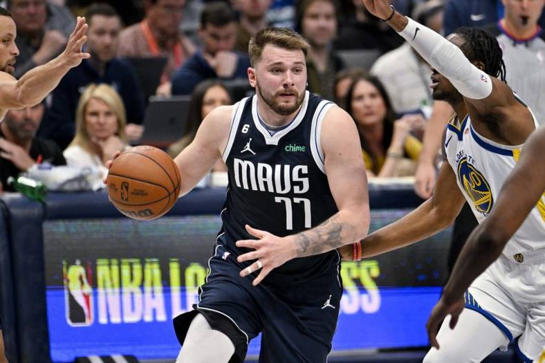 Mar 22, 2023; Dallas, Texas, USA; Dallas Mavericks guard Luka Doncic (77) drives to the basket against the Golden State Warriors during the second half at the American Airlines Center. Mandatory Credit: Jerome Miron-USA TODAY Sports
