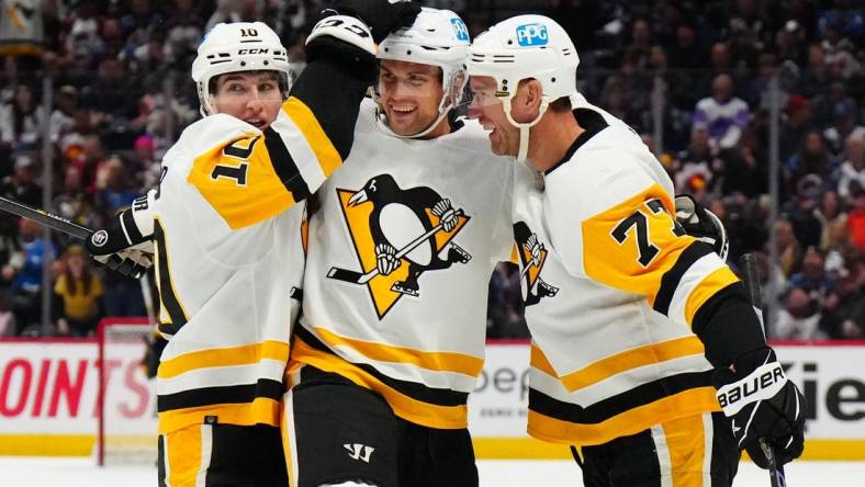 Mar 22, 2023; Denver, Colorado, USA; Pittsburgh Penguins center Jeff Carter (77) celebrates his goal with defenseman Brian Dumoulin (8) and left wing Drew O'Connor (10) in the third period against the Colorado Avalanche at Ball Arena. Mandatory Credit: Ron Chenoy-USA TODAY Sports