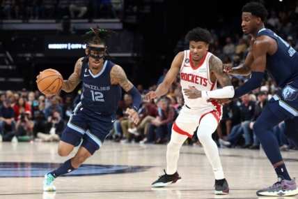 Mar 22, 2023; Memphis, Tennessee, USA; Memphis Grizzlies guard Ja Morant (12) drives to the basket as Houston Rockets guard Jalen Green (4) defends during the second half at FedExForum. Mandatory Credit: Petre Thomas-USA TODAY Sports