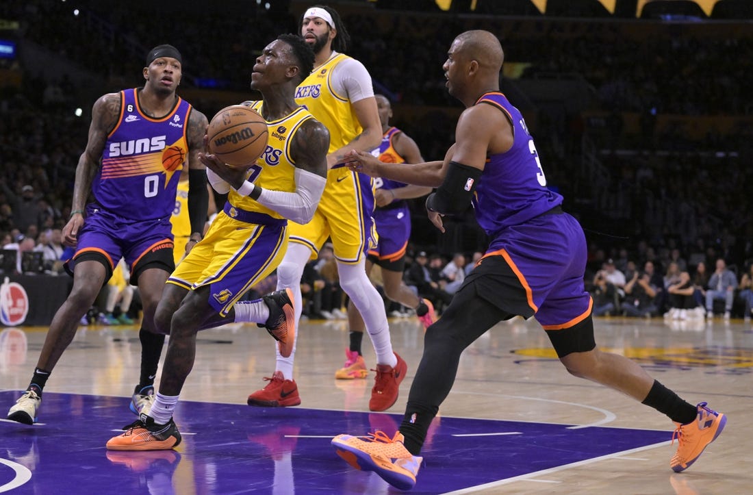 Mar 22, 2023; Los Angeles, California, USA;  Los Angeles Lakers guard Dennis Schroder (17) drives past Phoenix Suns guard Chris Paul (3) in the first half at Crypto.com Arena. Mandatory Credit: Jayne Kamin-Oncea-USA TODAY Sports