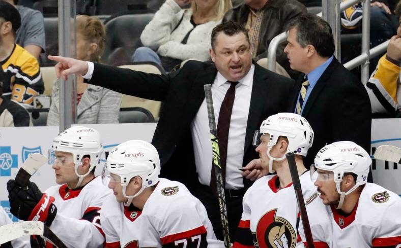 Mar 20, 2023; Pittsburgh, Pennsylvania, USA;  Ottawa Senators head coach D.J. Smith (left) talks with associate coach Jack Capuano (right) on the bench against the Pittsburgh Penguins at PPG Paints Arena. Mandatory Credit: Charles LeClaire-USA TODAY Sports