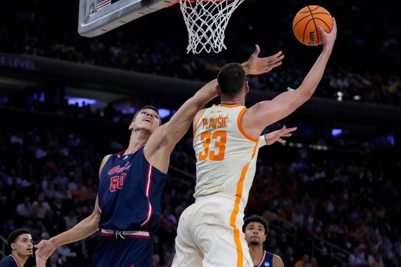 Mar 23, 2023; New York, NY, USA;  Tennessee Volunteers forward Uros Plavsic (33) drives to the basket against Florida Atlantic Owls center Vladislav Goldin (50) in the first half at Madison Square Garden. Mandatory Credit: Robert Deutsch-USA TODAY Sports
