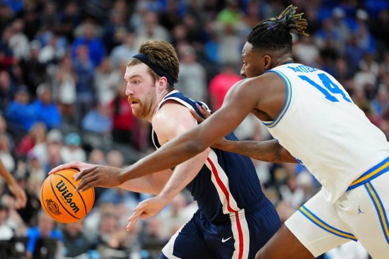 Mar 23, 2023; Las Vegas, NV, USA; Gonzaga Bulldogs forward Drew Timme (2) dribbles the ball against UCLA Bruins forward Kenneth Nwuba (14) during the second half at T-Mobile Arena. Mandatory Credit: Stephen R. Sylvanie-USA TODAY Sports