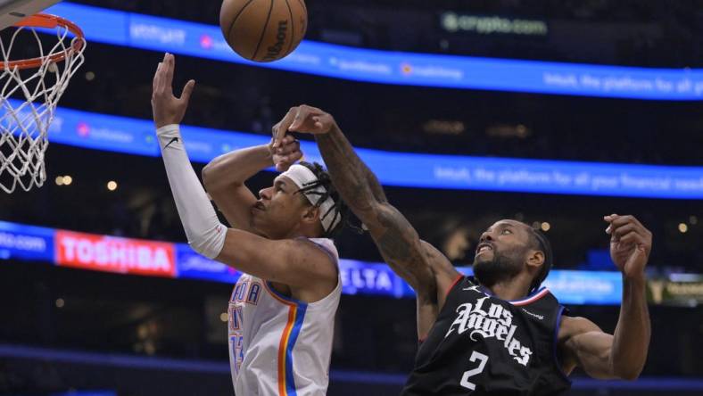 Mar 23, 2023; Los Angeles, California, USA; Los Angeles Clippers forward Kawhi Leonard (2) knocks the ball from Oklahoma City Thunder forward Ousmane Dieng (13) as he goes up for a shot in the second half at Crypto.com Arena. Mandatory Credit: Jayne Kamin-Oncea-USA TODAY Sports