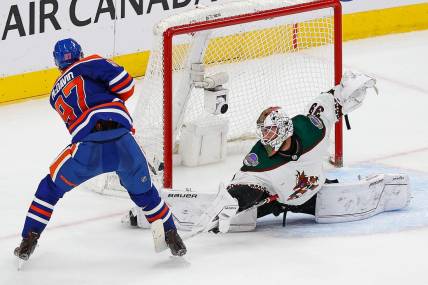 Mar 22, 2023; Edmonton, Alberta, CAN; Arizona Coyotes goaltender Connor Ingram (39) makes a save on Edmonton Oilers forward Connor McDavid (97) during overtime at Rogers Place. Mandatory Credit: Perry Nelson-USA TODAY Sports