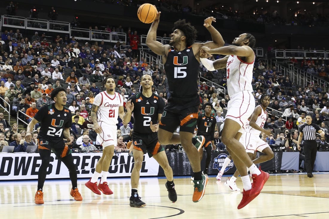 Mar 24, 2023; Kansas City, MO, USA; Miami Hurricanes forward Norchad Omier (15) and Houston Cougars forward J'Wan Roberts (13) fight for possession during the first half of an NCAA tournament Midwest Regional semifinal at T-Mobile Center. Mandatory Credit: William Purnell-USA TODAY Sports