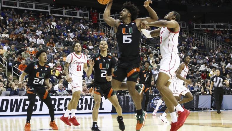 Mar 24, 2023; Kansas City, MO, USA; Miami Hurricanes forward Norchad Omier (15) and Houston Cougars forward J'Wan Roberts (13) fight for possession during the first half of an NCAA tournament Midwest Regional semifinal at T-Mobile Center. Mandatory Credit: William Purnell-USA TODAY Sports