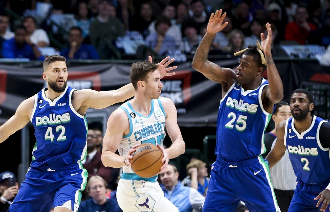 Mar 24, 2023; Dallas, Texas, USA;  Charlotte Hornets forward Gordon Hayward (20) looks to pass as Dallas Mavericks forward Reggie Bullock (25) and Dallas Mavericks forward Maxi Kleber (42) defend during the first quarter at American Airlines Center. Mandatory Credit: Kevin Jairaj-USA TODAY Sports