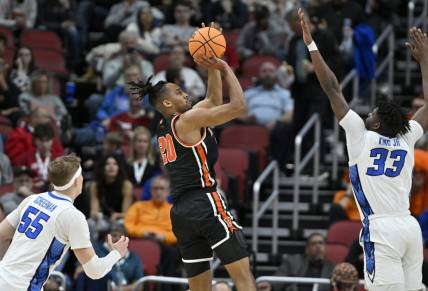 Mar 24, 2023; Louisville, KY, USA; Princeton Tigers forward Tosan Evbuomwan (20) shoots over Creighton Bluejays center Fredrick King (33) during the first half of the NCAA tournament round of sixteen at KFC YUM! Center. Mandatory Credit: Jamie Rhodes-USA TODAY Sports