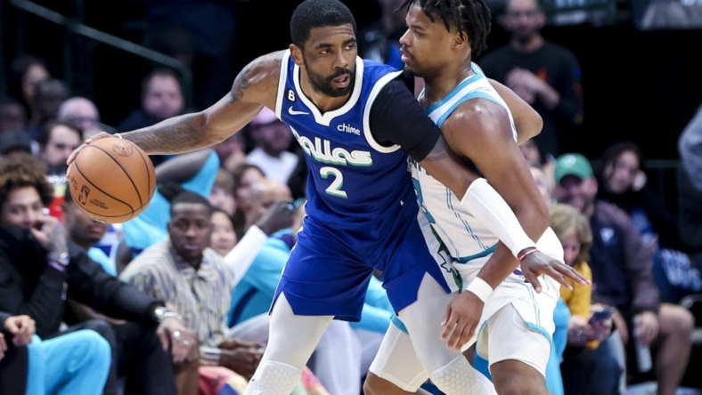 Mar 24, 2023; Dallas, Texas, USA;  Dallas Mavericks guard Kyrie Irving (2) controls the ball as Charlotte Hornets guard Dennis Smith Jr. (8) defends during the fourth quarter at American Airlines Center. Mandatory Credit: Kevin Jairaj-USA TODAY Sports