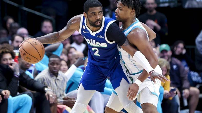 Mar 24, 2023; Dallas, Texas, USA;  Dallas Mavericks guard Kyrie Irving (2) controls the ball as Charlotte Hornets guard Dennis Smith Jr. (8) defends during the fourth quarter at American Airlines Center. Mandatory Credit: Kevin Jairaj-USA TODAY Sports