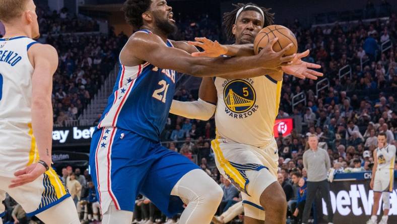 Mar 24, 2023; San Francisco, California, USA;  Philadelphia 76ers center Joel Embiid (21) is fouled in the act of shooting by Golden State Warriors forward Kevon Looney (5) during the second quarter at Chase Center. Mandatory Credit: Neville E. Guard-USA TODAY Sports