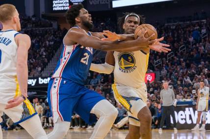 Mar 24, 2023; San Francisco, California, USA;  Philadelphia 76ers center Joel Embiid (21) is fouled in the act of shooting by Golden State Warriors forward Kevon Looney (5) during the second quarter at Chase Center. Mandatory Credit: Neville E. Guard-USA TODAY Sports