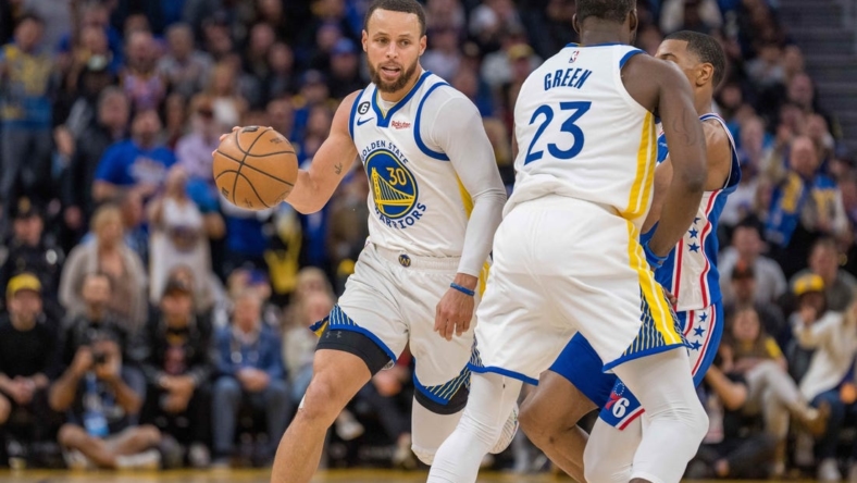 Mar 24, 2023; San Francisco, California, USA;  Golden State Warriors guard Stephen Curry (30) dribbles the basketball against the Philadelphia 76ers in the fourth quarter at Chase Center. Mandatory Credit: Neville E. Guard-USA TODAY Sports
