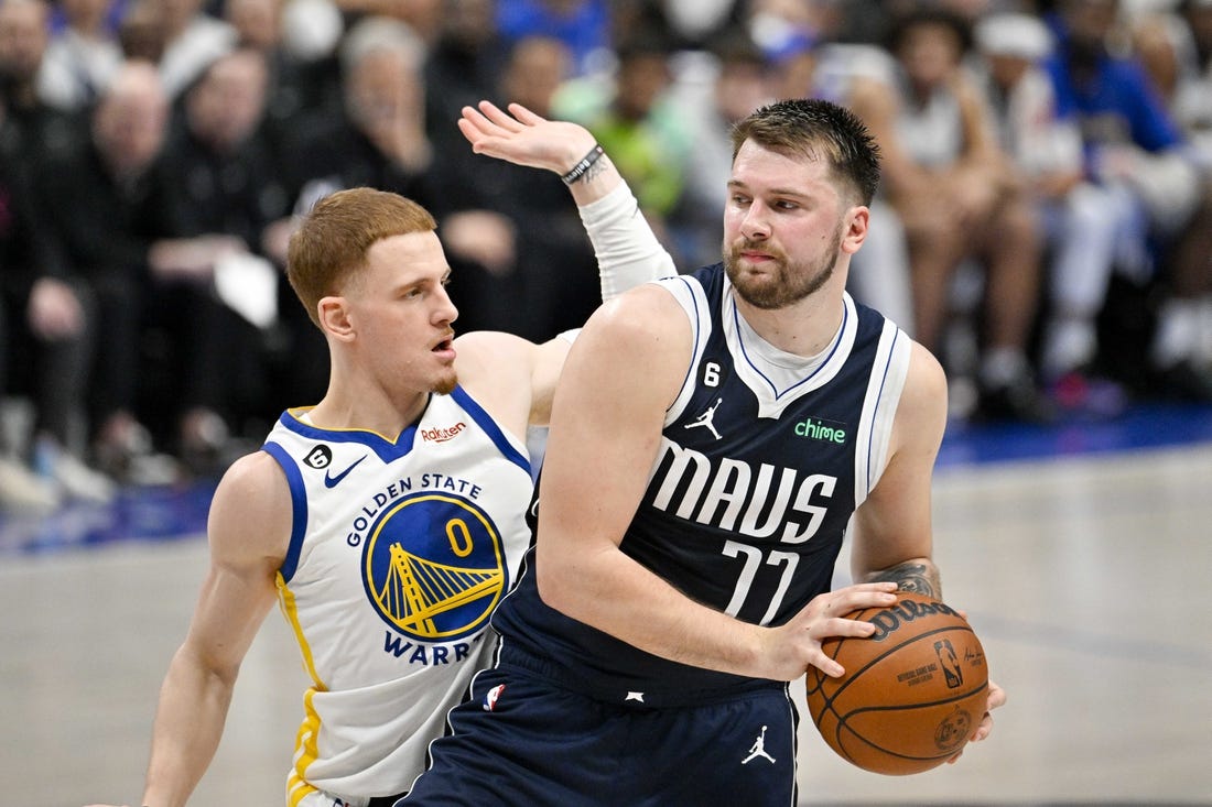 Mar 22, 2023; Dallas, Texas, USA; Golden State Warriors guard Donte DiVincenzo (0) and Dallas Mavericks guard Luka Doncic (77) in action during the game between the Dallas Mavericks and the Golden State Warriors at the American Airlines Center. Mandatory Credit: Jerome Miron-USA TODAY Sports