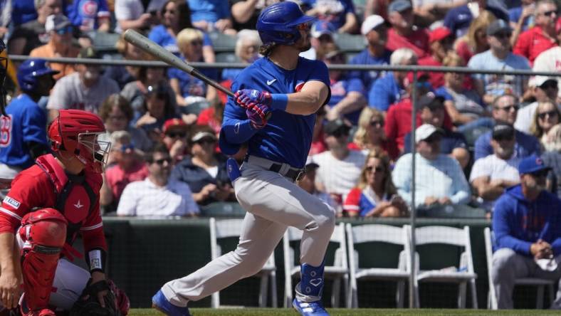 Mar 25, 2023; Tempe, Arizona, USA; Chicago Cubs third baseman Zach McKinstry (6) hits an RBI double against the Los Angeles Angels in the third inning at Tempe Diablo Stadium. Mandatory Credit: Rick Scuteri-USA TODAY Sports