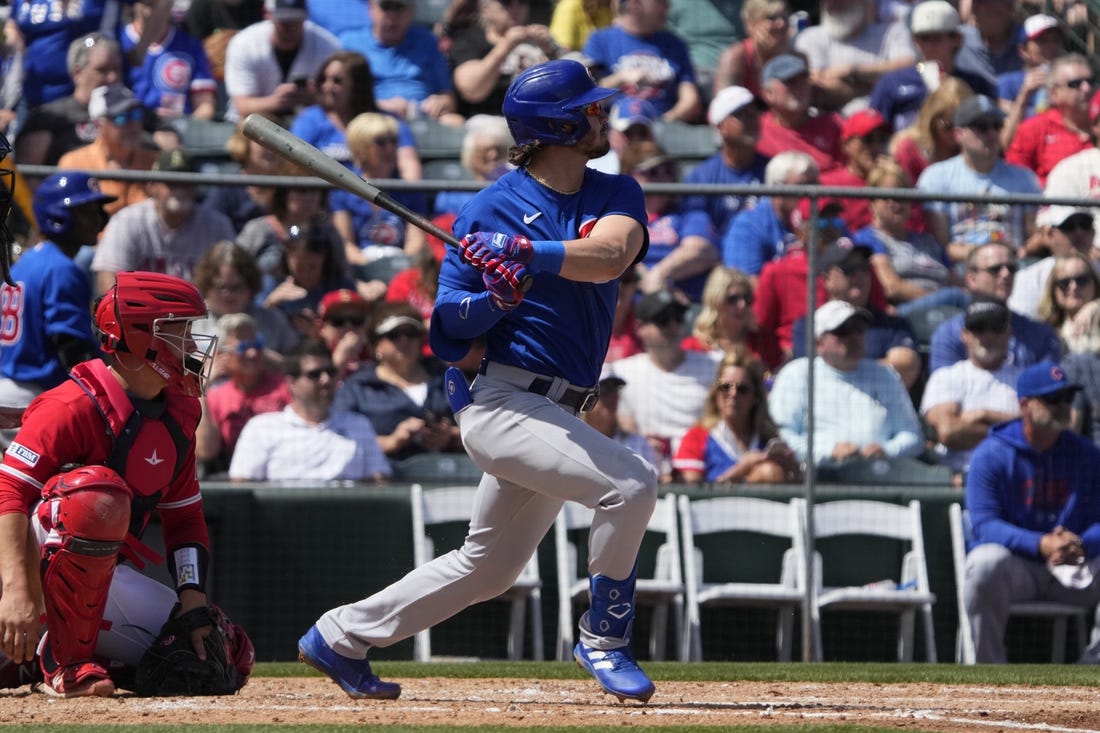 Mar 25, 2023; Tempe, Arizona, USA; Chicago Cubs third baseman Zach McKinstry (6) hits an RBI double against the Los Angeles Angels in the third inning at Tempe Diablo Stadium. Mandatory Credit: Rick Scuteri-USA TODAY Sports