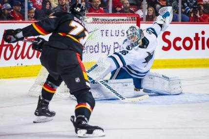 Mar 25, 2023; Calgary, Alberta, CAN; Calgary Flames right wing Walker Duehr (71) scores a goal against San Jose Sharks goaltender Kaapo Kahkonen (36) during the second period at Scotiabank Saddledome. Mandatory Credit: Sergei Belski-USA TODAY Sports