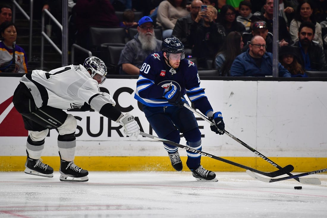 Mar 25, 2023; Los Angeles, California, USA; Winnipeg Jets left wing Pierre-Luc Dubois (80) moves the puck against Los Angeles Kings center Anze Kopitar (11) during the third period at Crypto.com Arena. Mandatory Credit: Gary A. Vasquez-USA TODAY Sports