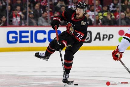 Mar 25, 2023; Newark, New Jersey, USA;  Ottawa Senators defenseman Thomas Chabot (72) shoots the puck into the zone against the New Jersey Devils during the first period at Prudential Center. Mandatory Credit: Dennis Schneidler-USA TODAY Sports