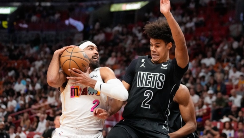 Mar 25, 2023; Miami, Florida, USA; Brooklyn Nets forward Cameron Johnson (2) fouls Miami Heat guard Gabe Vincent (2) during the first quarter at Miami-Dade Arena. Mandatory Credit: Rich Storry-USA TODAY Sports