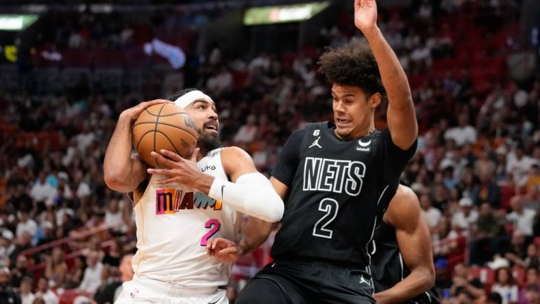 Mar 25, 2023; Miami, Florida, USA; Brooklyn Nets forward Cameron Johnson (2) fouls Miami Heat guard Gabe Vincent (2) during the first quarter at Miami-Dade Arena. Mandatory Credit: Rich Storry-USA TODAY Sports